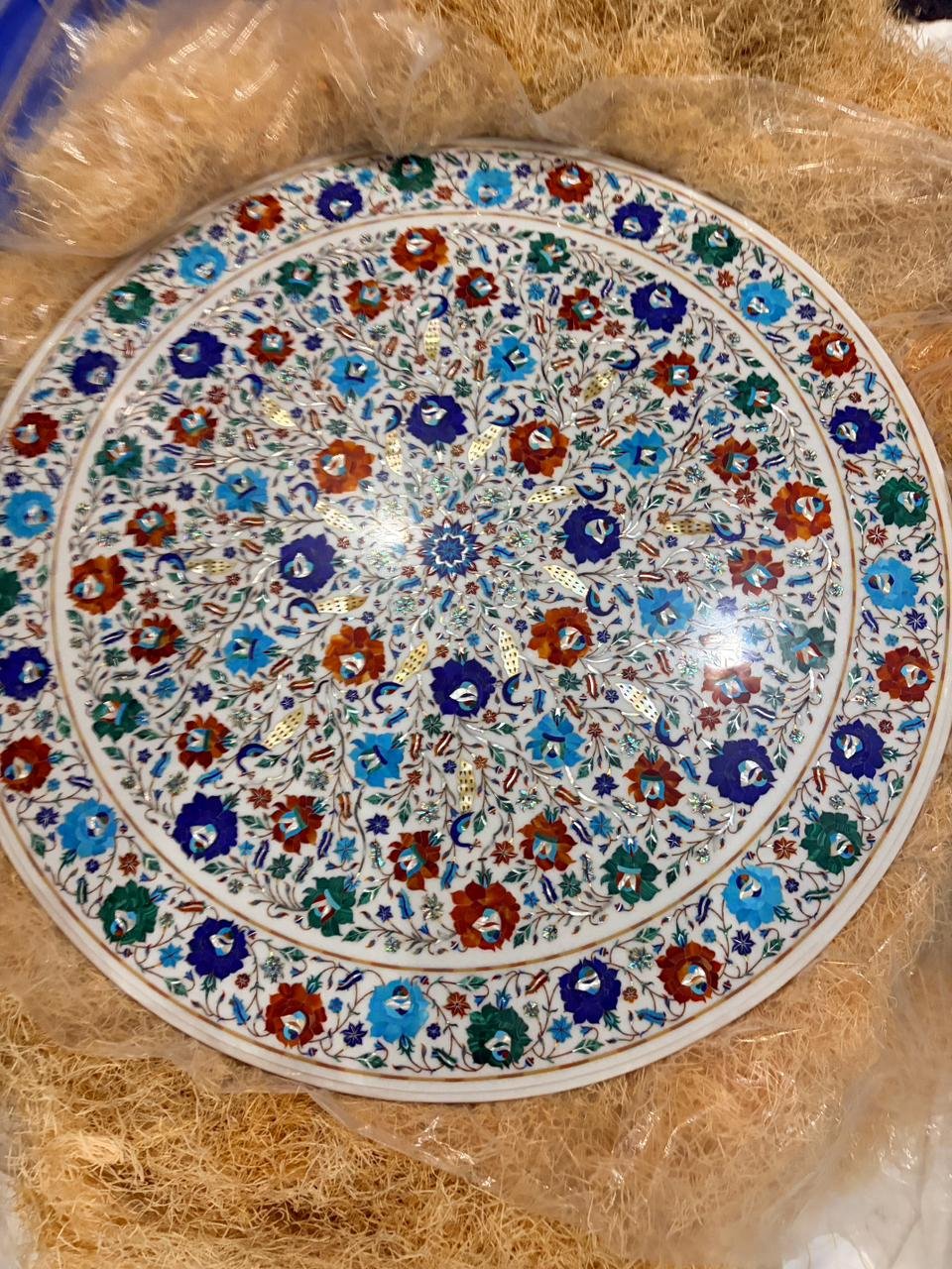The floral marble inlay tabletop shown in this project resting in protective cushioning during packing preparation